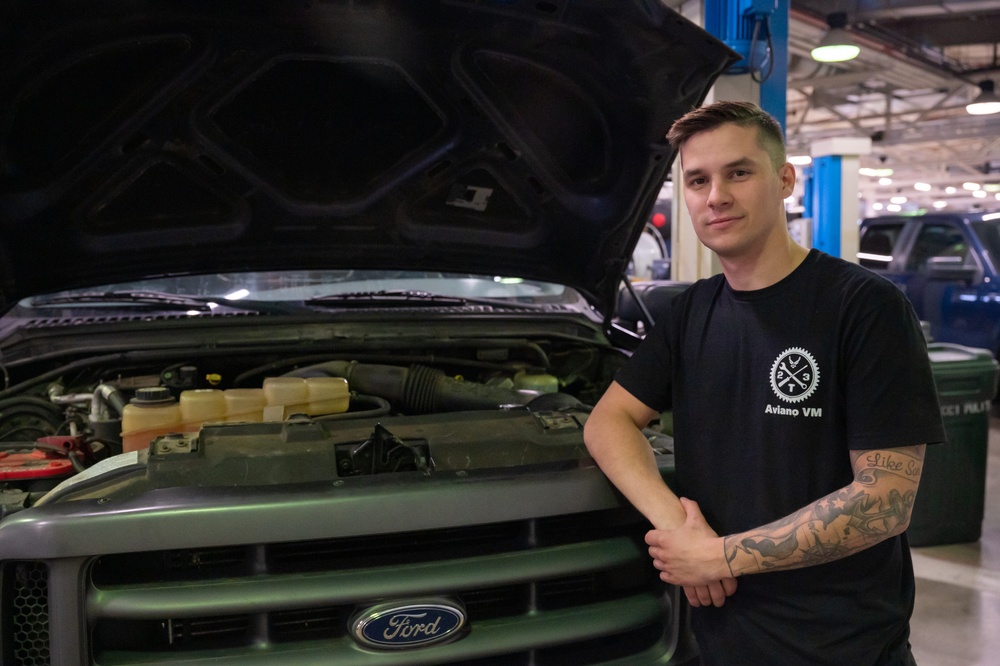 Niagara Reserve Airman poses for photo in vehicle maintenance shop