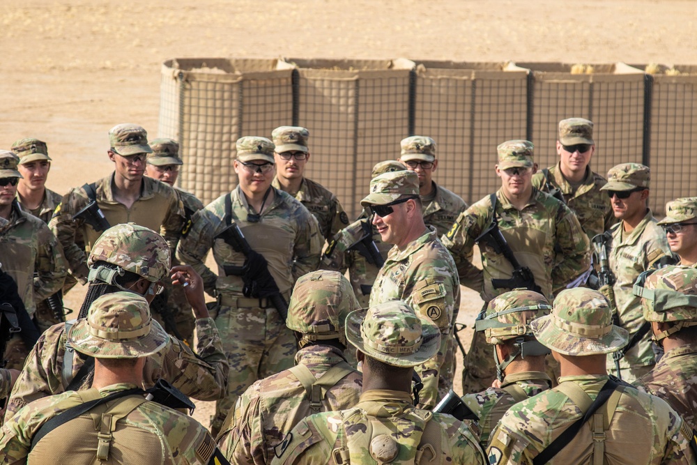 Command Sgt. Maj. Brian Disque speaks to the competitors after the land navigation course