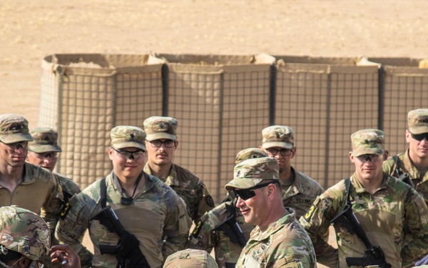 Command Sgt. Maj. Brian Disque speaks to the competitors after the land navigation course