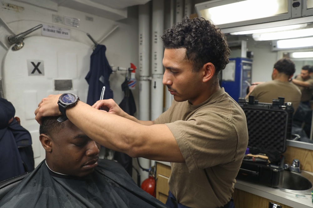 USS Ramages Sailor Gives a Haircut