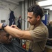 USS Ramages Sailor Gives a Haircut