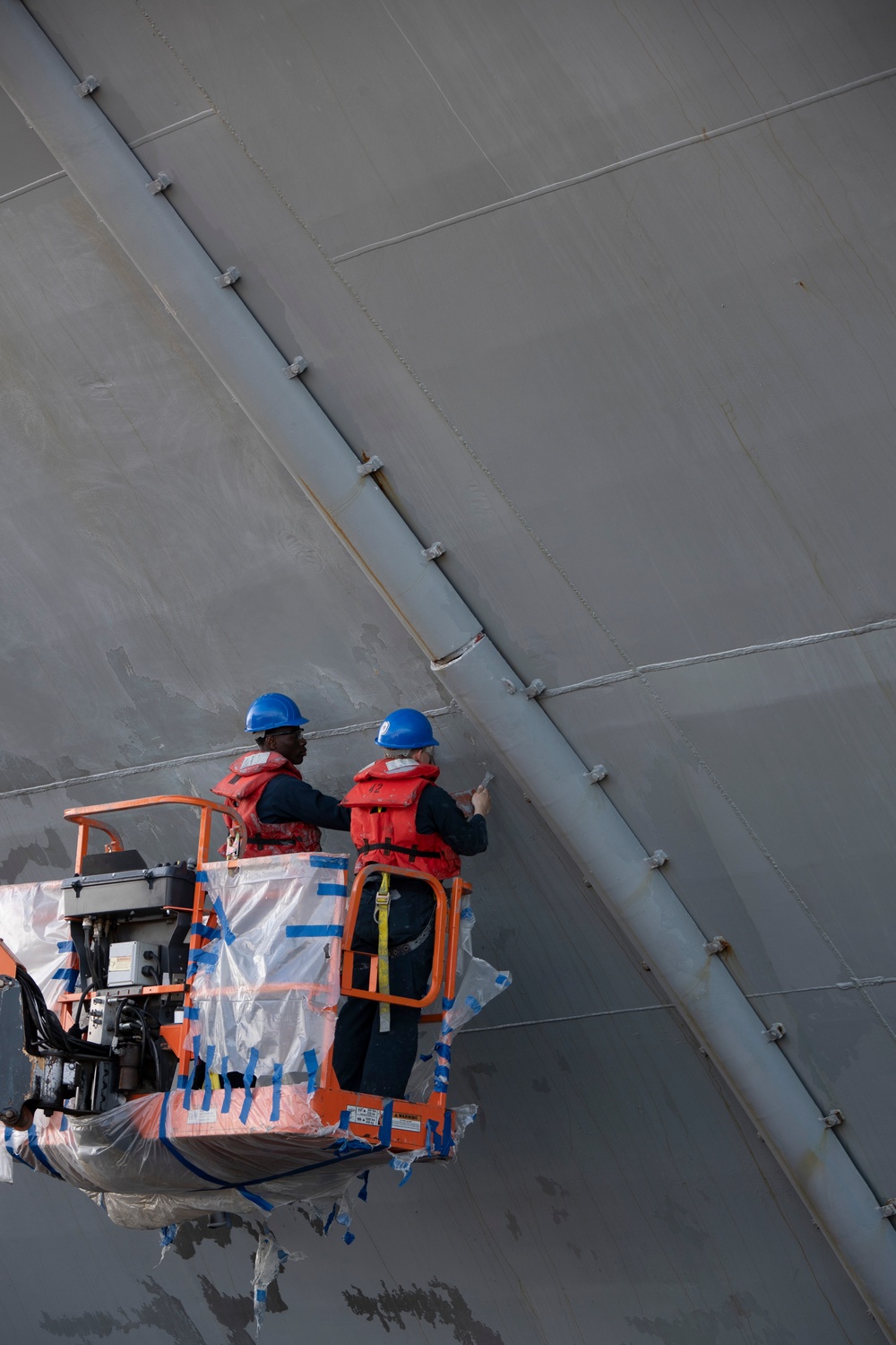 USS Tripoli Sailors Continue To Paint The Ship’s Hull During SRA