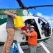 USDA staff smile for the camera while refueling between bait drops