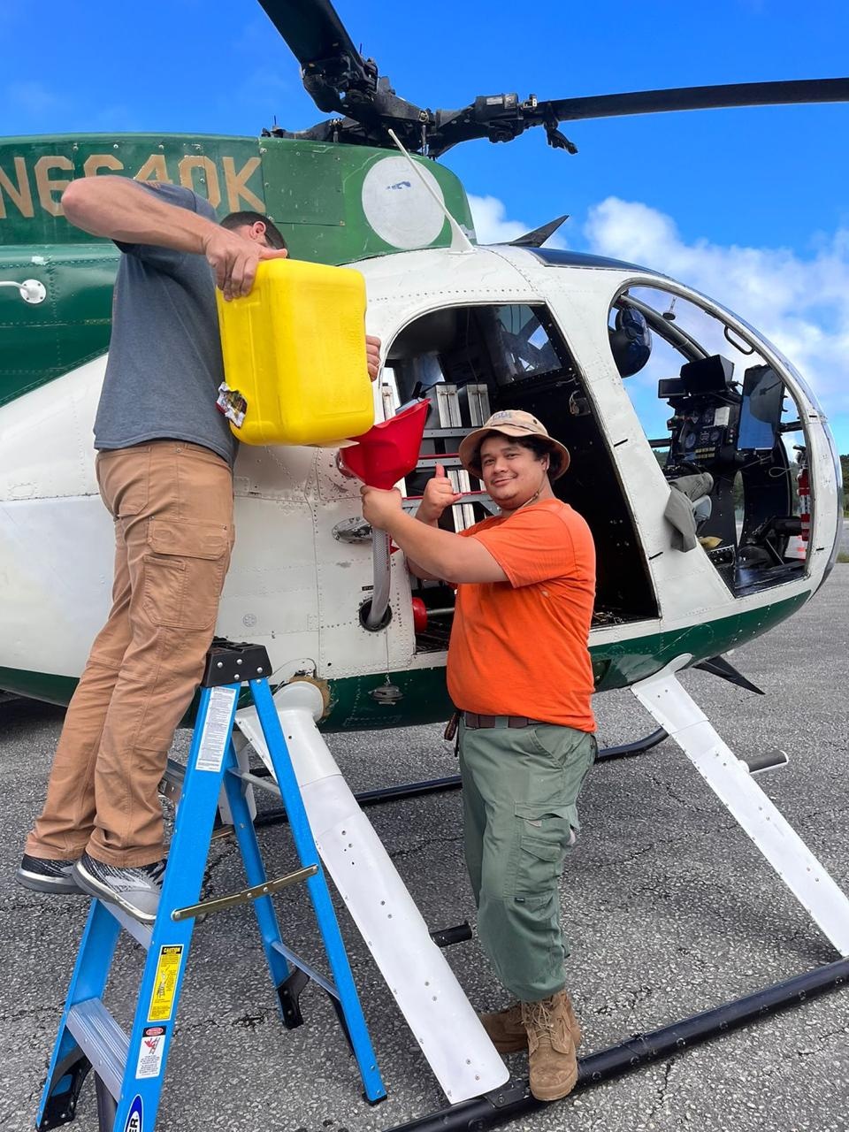 USDA staff smile for the camera while refueling between bait drops