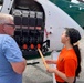 USDA staff prep an automated bait dispenser in a UH-6 helicopter