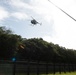 UH-6 helicopter makes a pass over a fenced habitat management unit on Andersen Air Force Base