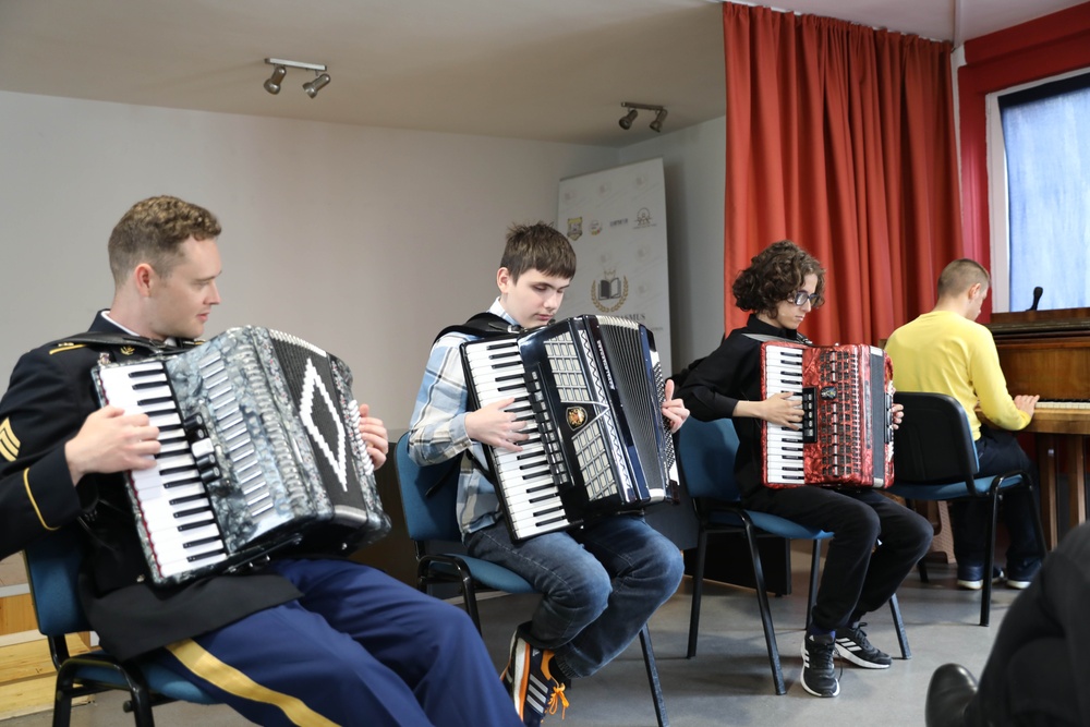 U.S. Army Sgt. Erik Lofgren plays the accordian with Daniel Donav, Aljidin Murati, and Filip Veliclovski at Durdmov Dimitar Vlahov