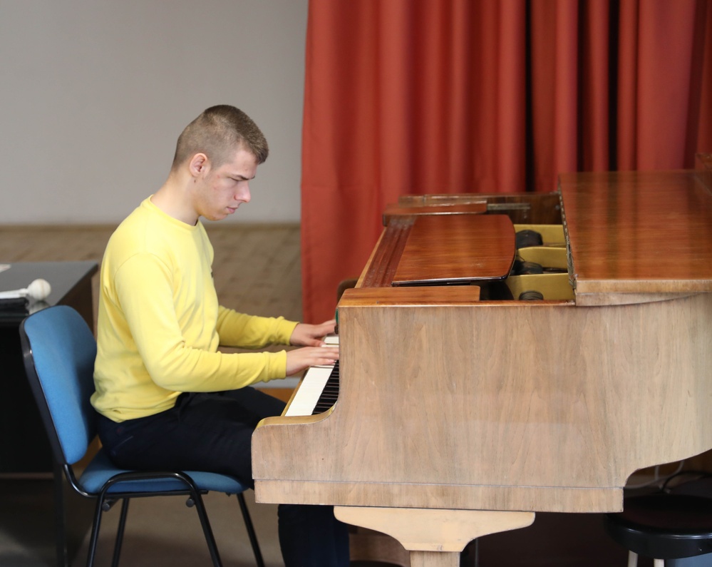 Daniel Donav plays the piano at Durdmov Dimitar Vlahov, State School of the Visually Impaired in a cultural exchange concert.