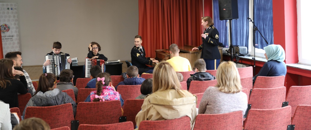 U.S. Army Staff Sgt. Katherine Bolcar and Sgt. Erik Lofgren sing a traditional Portuguese song in a cultural exchange event