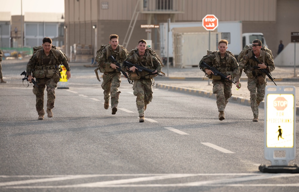 Soldiers running to the ruck march finish line during USARCENT Best Squad Competition 2023