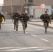 Soldiers running to the ruck march finish line during USARCENT Best Squad Competition 2023