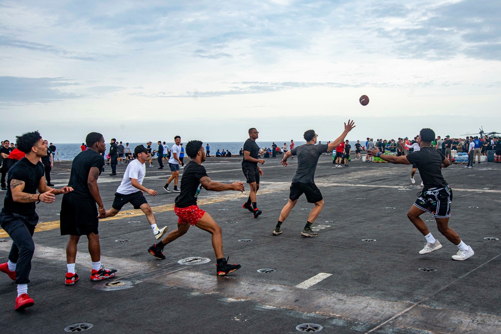 Sailors Play Football On The Flight Deck During Steel Beach Picnic