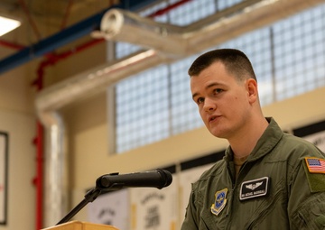 Airman thanks Yokota educators for 50 years of service with combat flag
