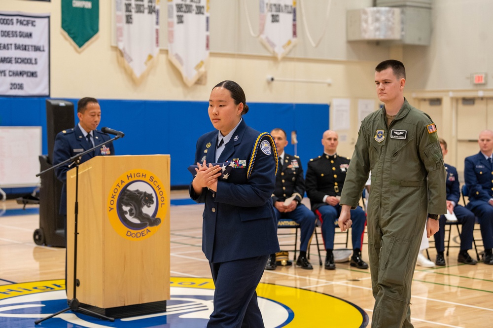 Airman thanks Yokota educators for 50 years of service with combat flag