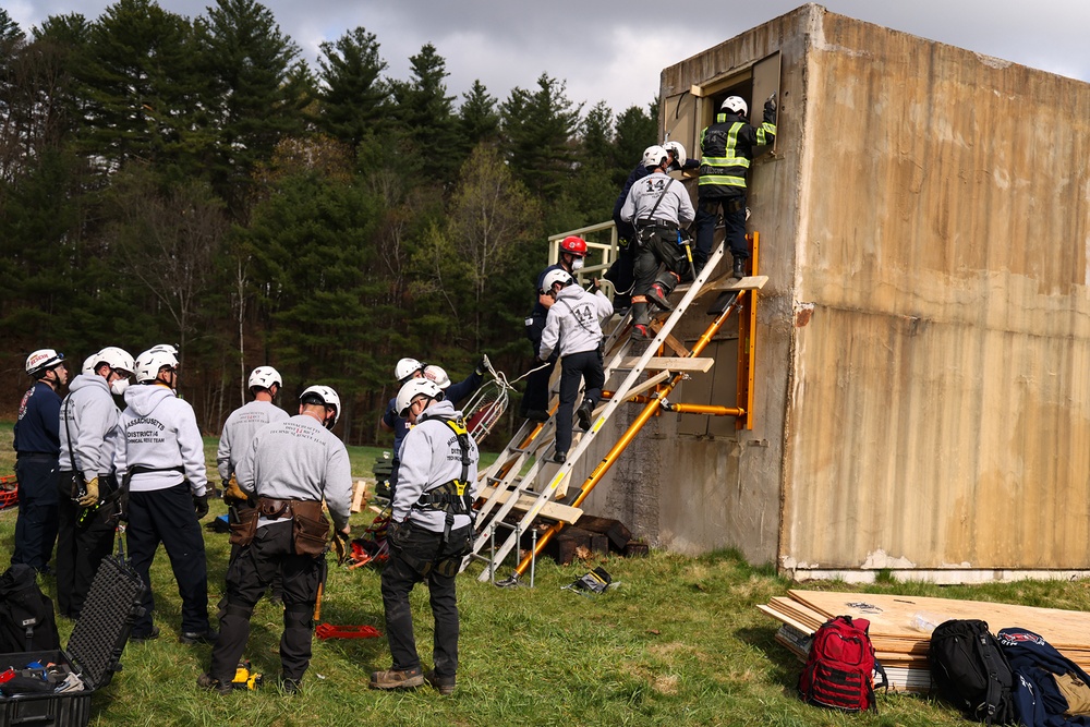 Members of the District 8, Massachusetts Bureau of Forest Control access a building