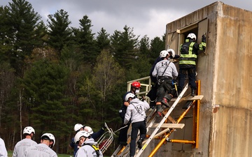 Members of the District 8, Massachusetts Bureau of Forest Control access a building