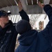 USCGC Eagle crew members maintain upkeep of the training vessel while underway