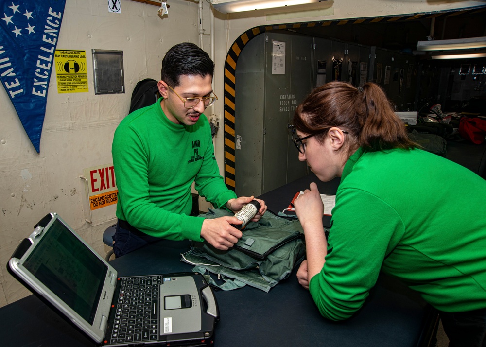 Sailors Inspect Parachute Survival Kit