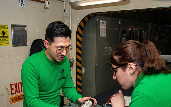 Sailors Inspect Parachute Survival Kit