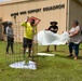 A newly planted native plant is given added protection by a team of natural resource specialists on Marine Corps Base Camp Blaz