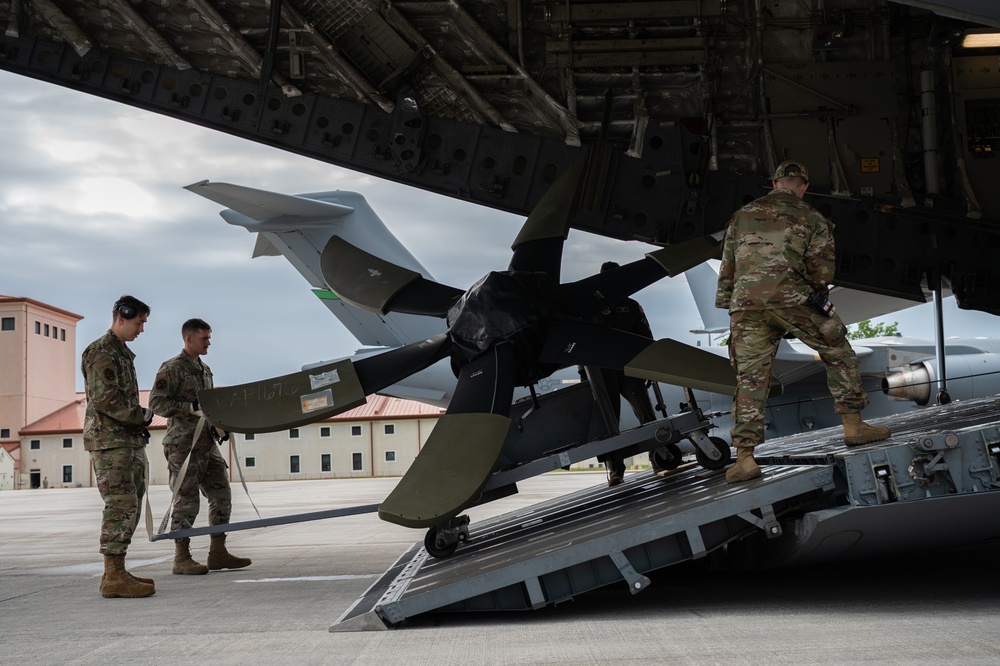 Airmen load aircraft propeller onto C-17