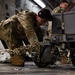 190th Air Refueling Wing airman tightens down cargo on C-17