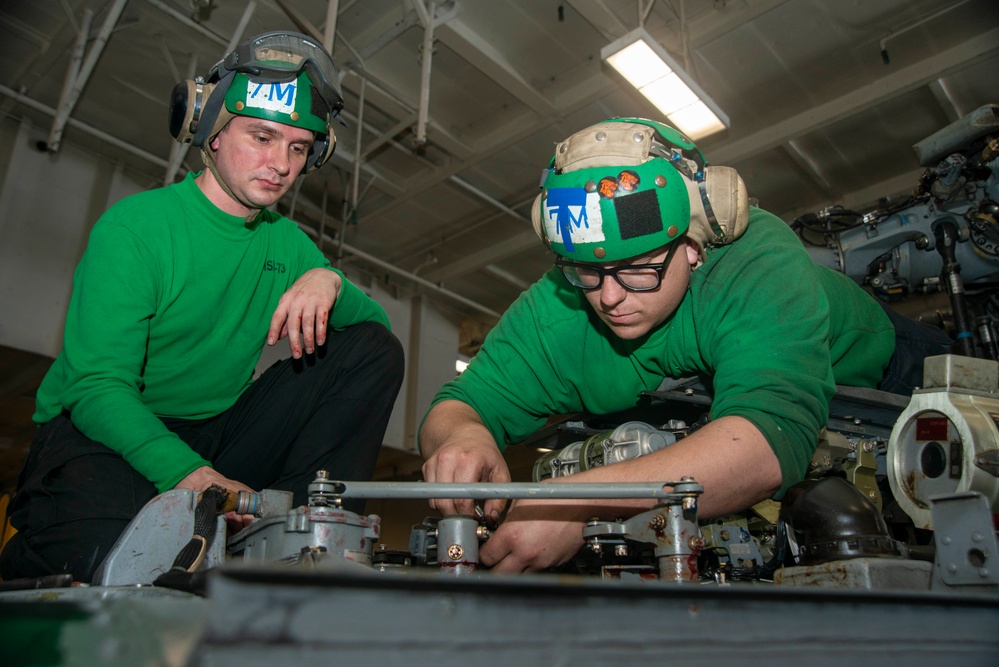 Sailors Perform Flight Control Inspection On A Helicopter