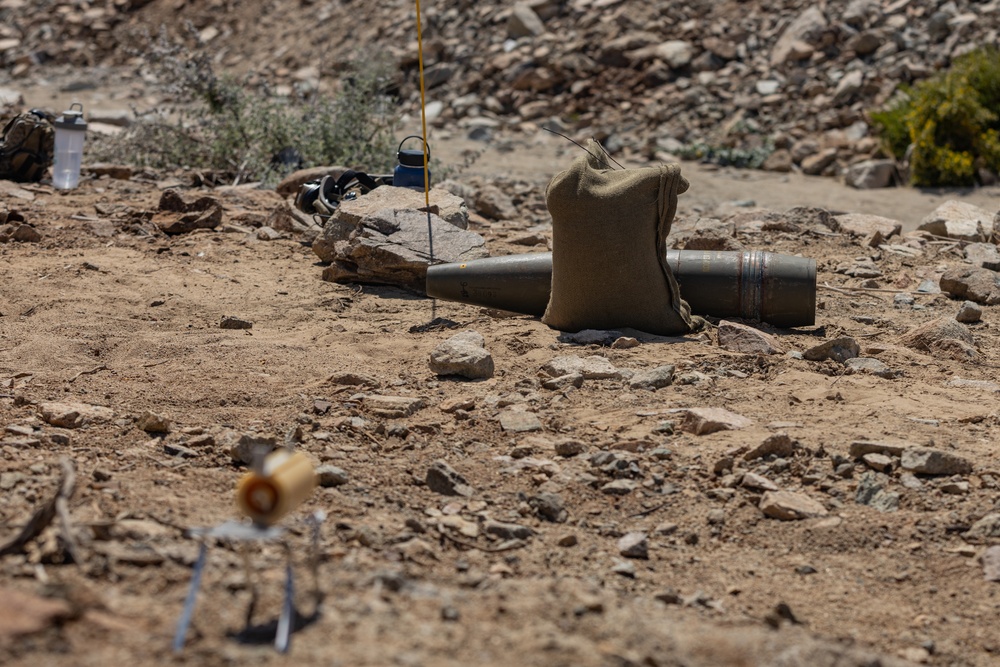 EOD Technicians plant controlled explosives as part of a training and documentation exercise for future EOD classes