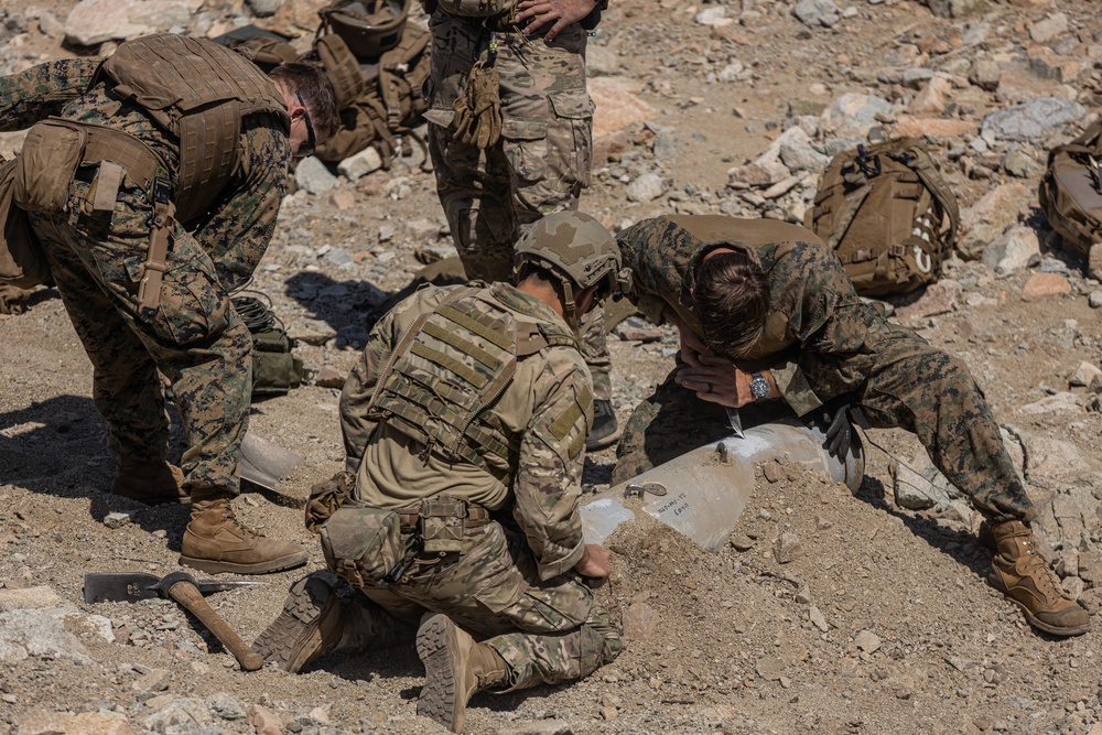 EOD Technicians plant controlled explosives as part of a training and documentation exercise for future EOD classes