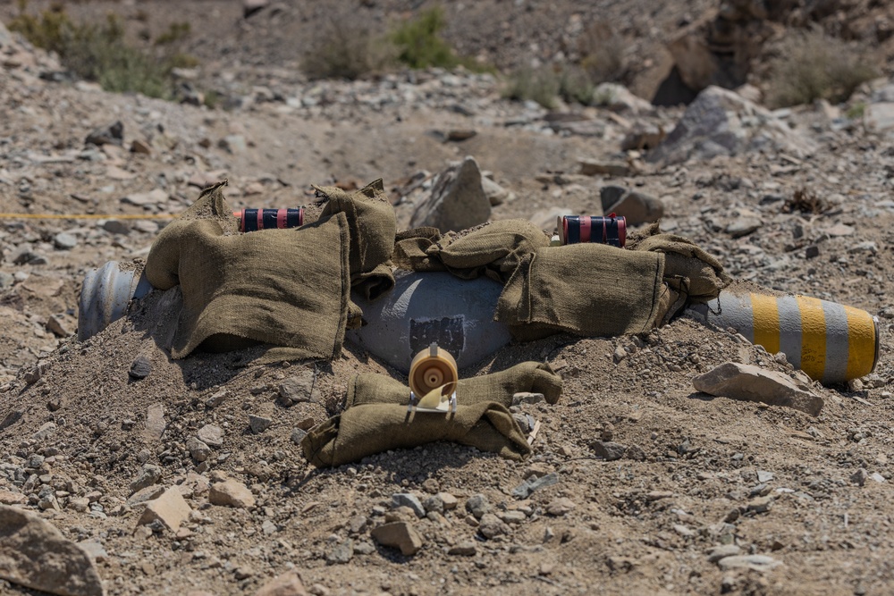 EOD Technicians plant controlled explosives as part of a training and documentation exercise for future EOD classes