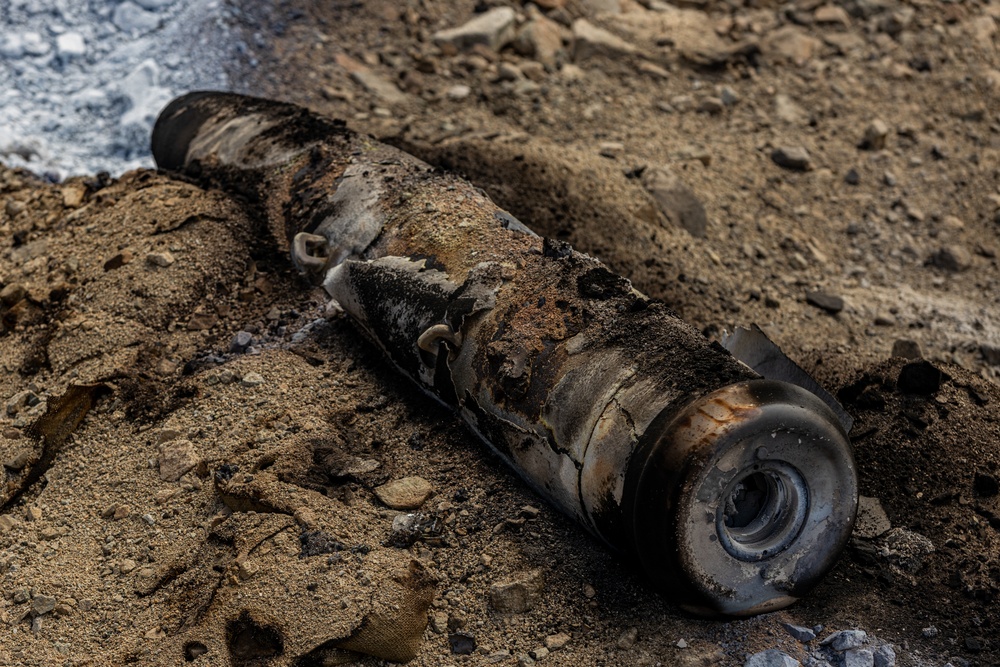 EOD Technicians plant controlled explosives as part of a training and documentation exercise for future EOD classes