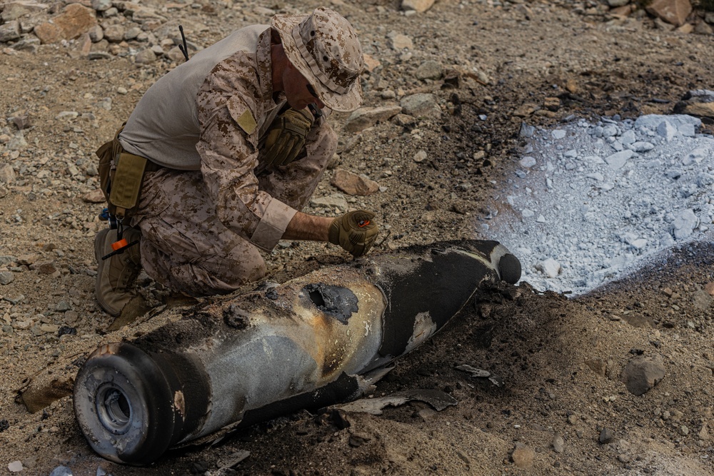 EOD Technicians plant controlled explosives as part of a training and documentation exercise for future EOD classes