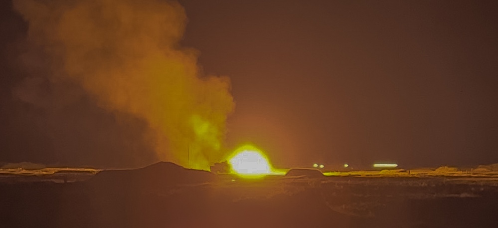 Abrams fire rounds during night fire