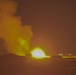 Abrams fire rounds during night fire