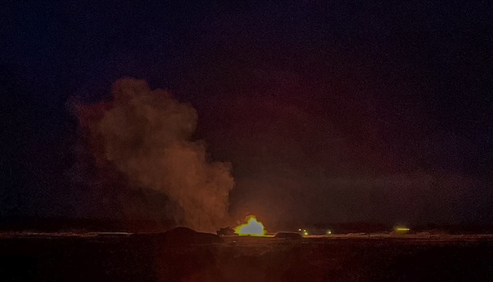 Abrams fire rounds during night fire