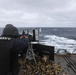 USS Ramage Sailor Fires Machine Gun