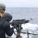 USS Ramage Sailor Fires Machine Gun