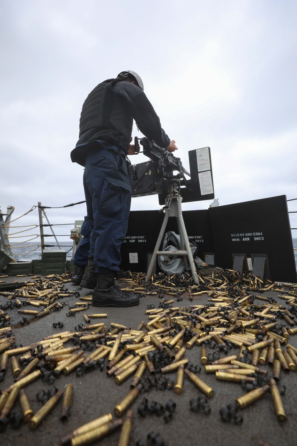 USS Ramage Sailor Surrounded by Ammo Casings