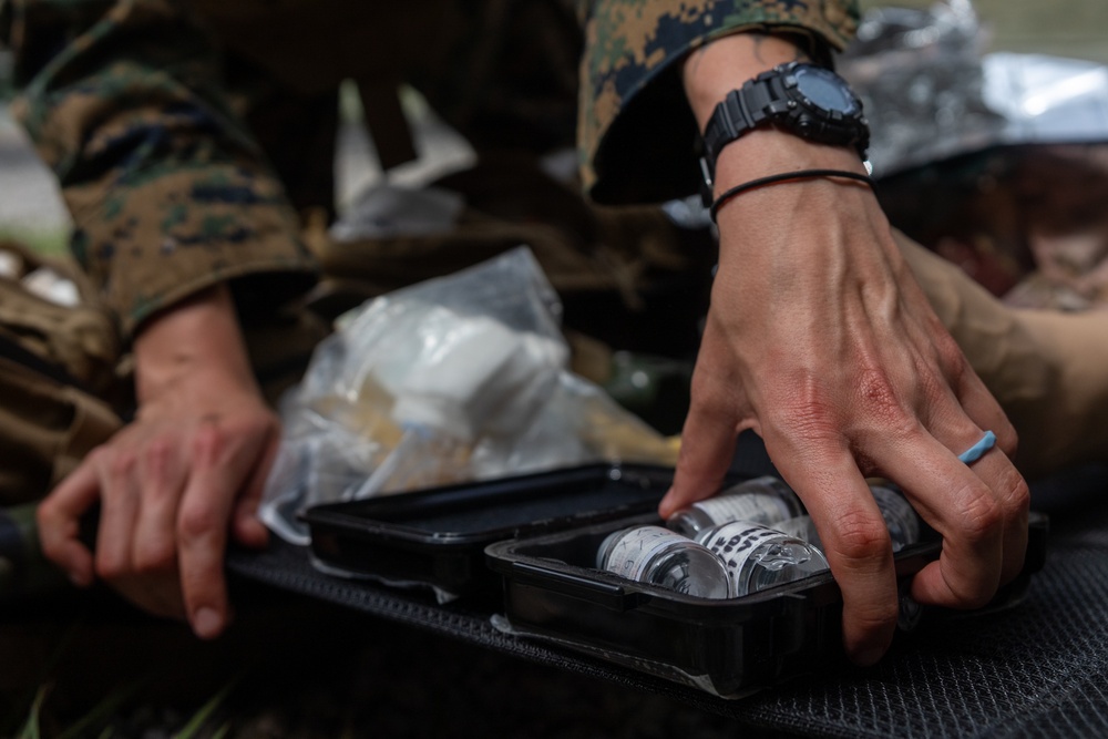 U.S. Navy Sailors conduct a Tactical Casualty Care Tier Three Instructor test
