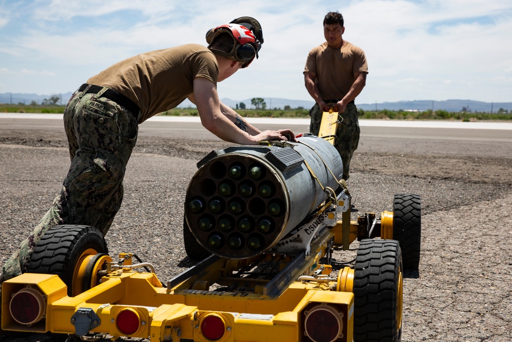 Aviation Ordnanceman mount LAU-61 G/A Digital Rocket Launcher onto an MH-60S