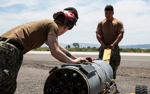Aviation Ordnanceman mount LAU-61 G/A Digital Rocket Launcher onto an MH-60S