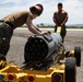 Aviation Ordnanceman mount LAU-61 G/A Digital Rocket Launcher onto an MH-60S