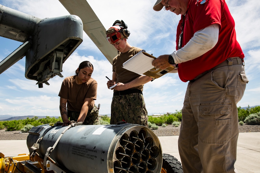 Aviation Ordnanceman mount LAU-61 G/A Digital Rocket Launcher onto an MH-60S