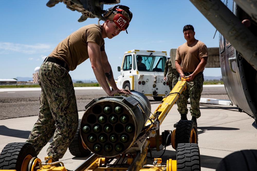 Aviation Ordnanceman mount LAU-61 G/A Digital Rocket Launcher onto an MH-60S