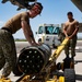 Aviation Ordnanceman mount LAU-61 G/A Digital Rocket Launcher onto an MH-60S