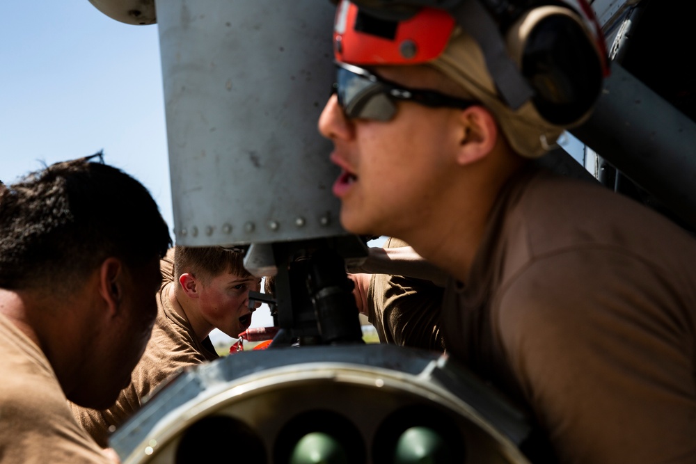 Aviation Ordnanceman mount LAU-61 G/A Digital Rocket Launcher onto an MH-60S