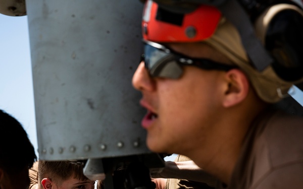 Aviation Ordnanceman mount LAU-61 G/A Digital Rocket Launcher onto an MH-60S