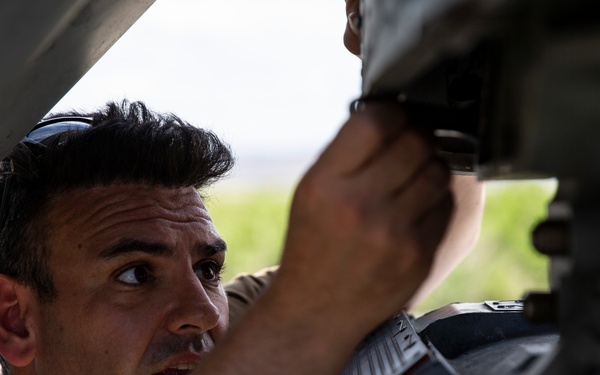 Aviation Ordnanceman mount LAU-61 G/A Digital Rocket Launcher onto an MH-60S