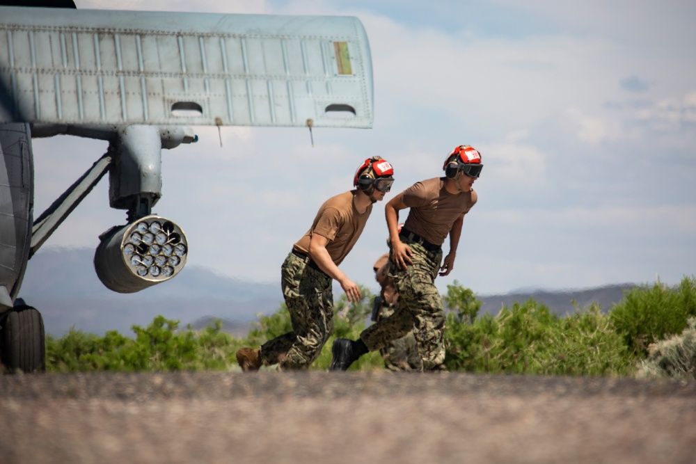 Aviation Ordnanceman mount LAU-61 G/A Digital Rocket Launcher onto an MH-60S