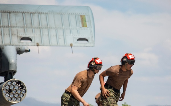 Aviation Ordnanceman mount LAU-61 G/A Digital Rocket Launcher onto an MH-60S
